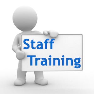 Image of a stick figure holding a sign that reads "Staff Training"